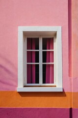 Obraz premium Portrait of pink window on colorful wall background 