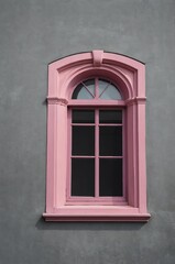 Obraz premium Portrait of pink window on gray wall background 