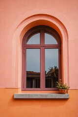 Obraz premium Portrait of orange window on pink wall background 
