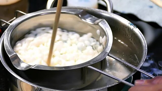 The process of melting wax for candles.