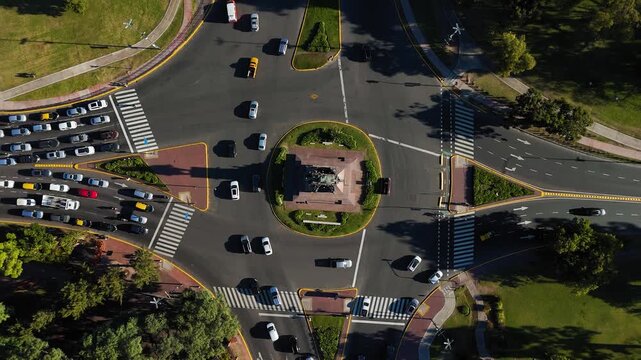 Aerial rotating shot of cars driving around a traffic circle Urquiza Monument