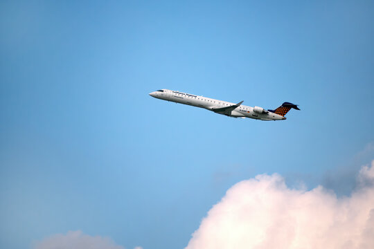 A big Lufthansa jet taking off in blue cloudy sky: Munich, Germany - September 15, 2018
