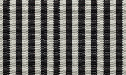 Black and white striped fabric texture. High resolution close-up of vertical stripes textile.
