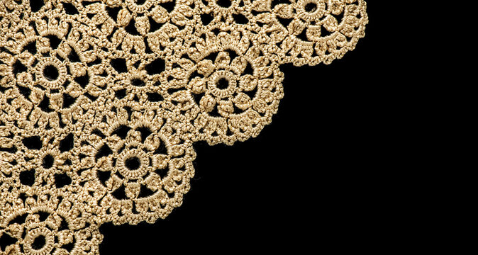 Crochet lace patterns, crocheted Grandmas Doily, Detail of hand-crocheted tablecloth isolated on black background border art design. Craft, vintage linen. Hobby concept. flat lay. 