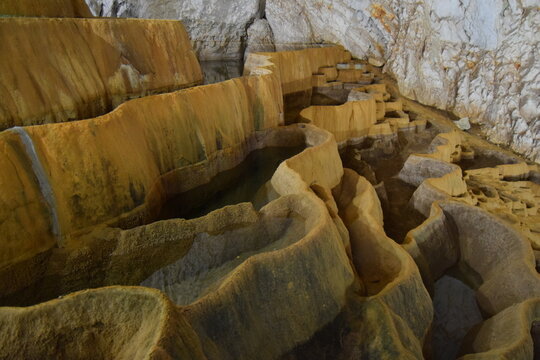 Natural limestone tufa pools and terraces inside a cave