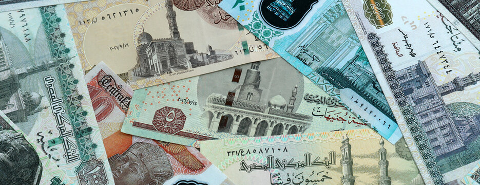 Egyptian pound money banknotes pile on table. Egypt bills of EGP currency. Concept of economy