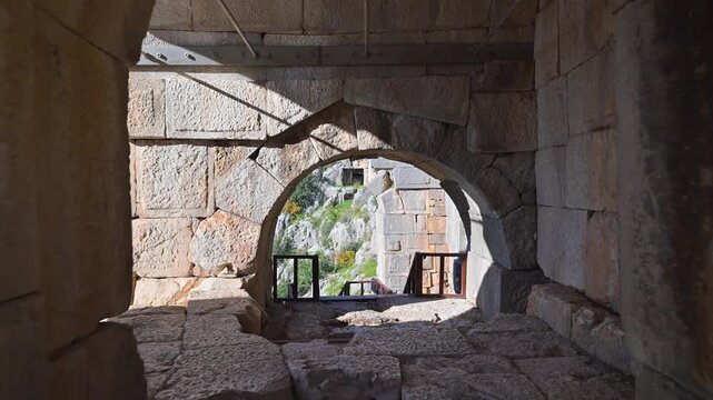 Walking through an ancient tunnel revealing the Myra rock tombs