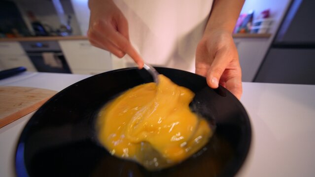 Baker combines ingredients. Morning baker mixes egg components