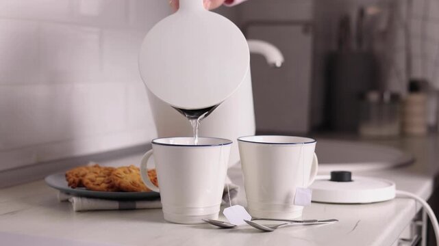 Pure water boils in an electric kettle on the table in the kitchen