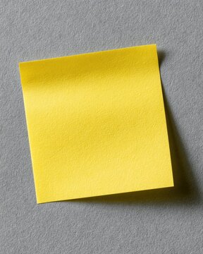 Yellow post it note isolated on transparent gray background with realistic paper texture and shadow