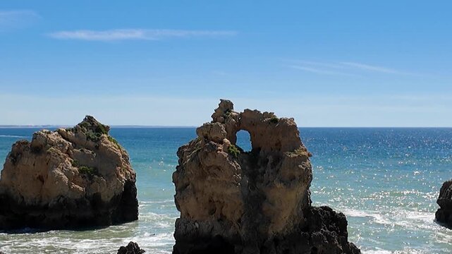 A tight zoom shot focuses on one of the striking rock formations at Praia dos Arrifes, revealing the raw texture, colour and detail of the ancient stone shaped by centuries of Atlantic waves