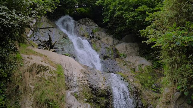 Slow motion: Andrew the Apostle waterfall in the mountain - river or stream of water is flowing and falling down. Nature, landscape and environment concept
