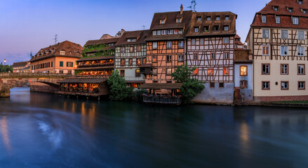 Obraz premium Half timbered houses by canals of Petite France in Strasbourg, France at sunset