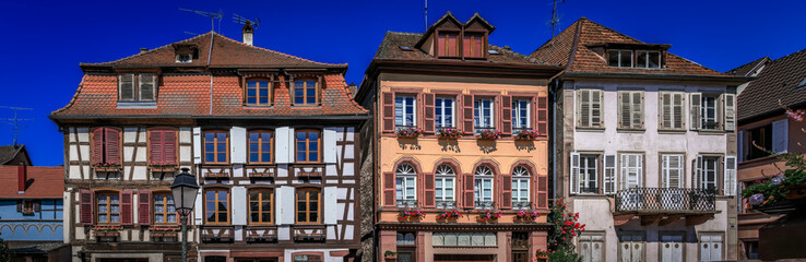 Fototapeta premium Ornate half timbered houses, flowers in Ribeauville, France, Alsatian Wine Route
