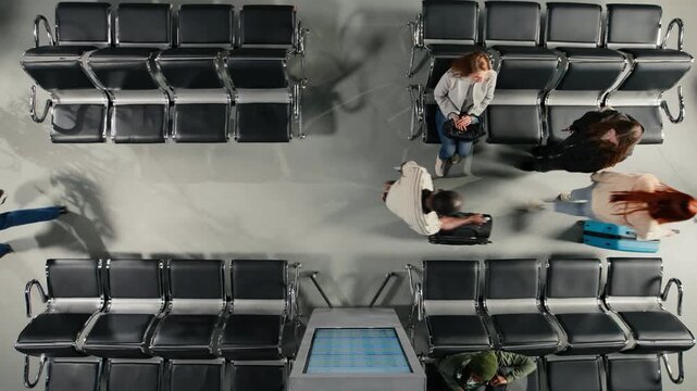 Walking, FIDS electronic display and top down view of people in crowded airport. Navigating busy transit hub, long flight layover and passengers passing by departure board display
