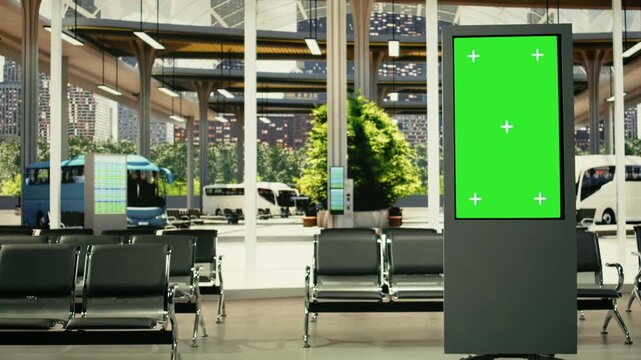 Green screen on TV board in empty bus stop terminal in the city, departure time screen, public transportation routes. Quiet station featuring platform access and travel information displays.
