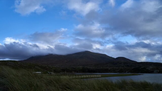 Time-lapse of candy floss clouds over the mountains. Shot during daytime with some amazing mountains in the backdrop. High quality Full HD footage