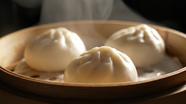 Steaming dumplings in bamboo steamer, warm close up