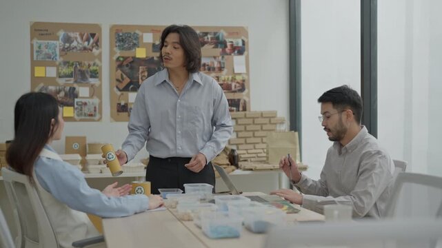 Team meeting office startup coworkers discussion presentation planning collaboration project workspace creative business workshop packaging design product sample office interior cardboard package