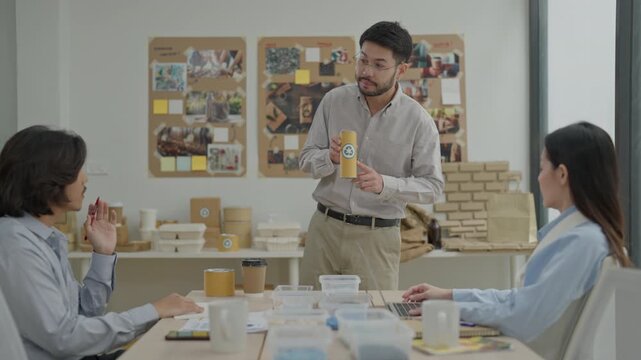 Business Presentation Sustainable Packaging Office Meeting Product Prototype Cardboard Box Paper Cup Design Team Indoor Workspace Man Presenter Eco Friendly Collaboration Startup Packaging Design