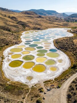 Aerial view of Spotted Lake Kliluk with colorful mineral pools and white salt deposits in Osoyoos British Columbia Canada, sacred natural wonder