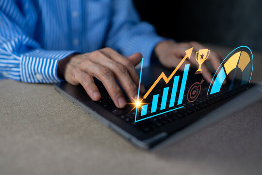 Businessman typing on laptop with business growth graph and KPI dashboard icons