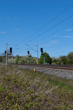 Transportation / Railway: Two modern catenary posts and state-of-the-art signaling technology on an electrified railway line in Central Germany