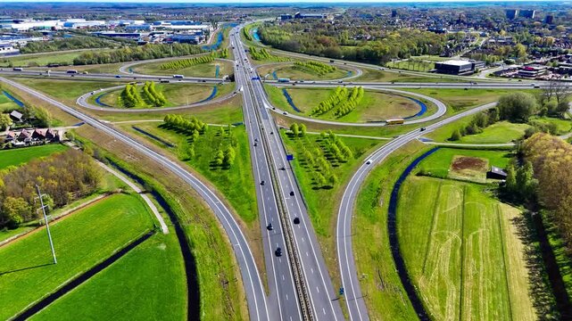 Aerial drone view road junction. Clover roundabout view from above. Car traffic on autobahn Netherlands. . High quality 4k footage
