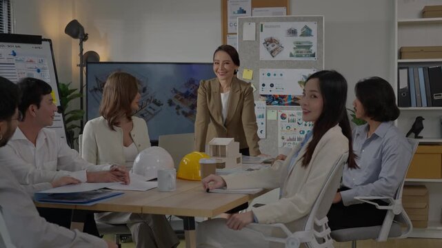 Diverse business team office meeting with architecture model and project plan, professional group discussion, corporate workspace collaboration, business meeting office team female manager project