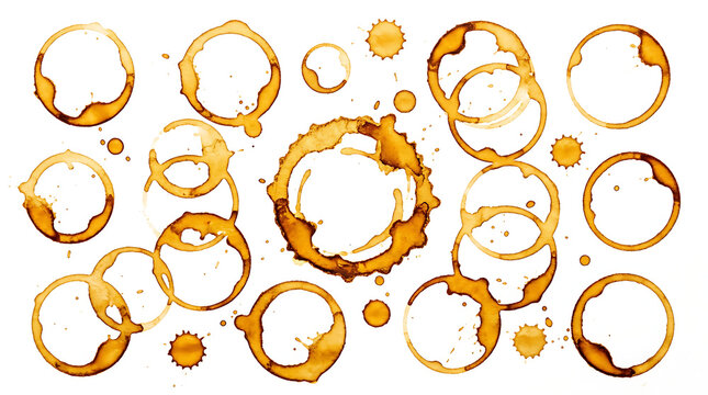 Collection of coffee or tea stain rings and marks on white surface with varied sizes shapes and shades of brown creating an abstract