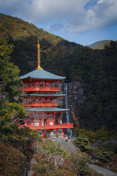 Vermilion three-storied pagoda of Seiganto-ji Temple and Nachi Falls, sacred site of Kumano Nachi, Wakayama, Japan