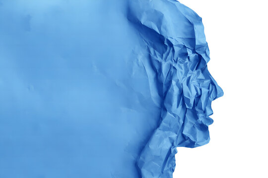 Crinkled blue fabric forming a human face profile with creative texture on white background for conceptual design