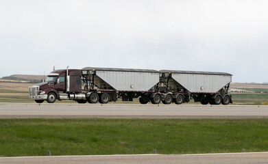 Fototapeta premium Heavy Cargo on the Road. A truck hauling freight along a highway