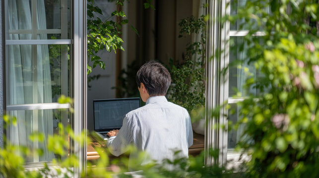 Person working on laptop on a garden patio