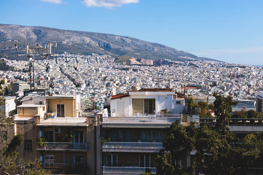 Athens, Attica, Greece, beautiful panoramic view of Athens cityscape, with The Parthenon, mountains, sea and scenery beyond the city, seen from Mount Lycabettus Hill observation deck in a sunny day