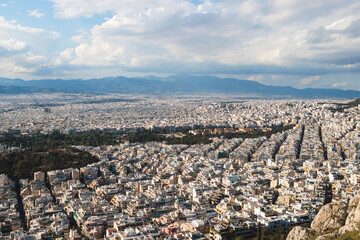 Fototapeta premium Athens, Attica, Greece, beautiful panoramic view of Athens cityscape, with The Parthenon, mountains, sea and scenery beyond the city, seen from Mount Lycabettus Hill observation deck in a sunny day