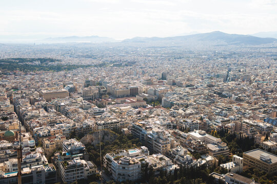 Athens, Attica, Greece, beautiful panoramic view of Athens cityscape, with The Parthenon, mountains, sea and scenery beyond the city, seen from Mount Lycabettus Hill observation deck in a sunny day