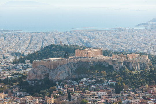 Athens, Attica, Greece, beautiful panoramic view of Athens cityscape, with The Parthenon, mountains, sea and scenery beyond the city, seen from Mount Lycabettus Hill observation deck in a sunny day