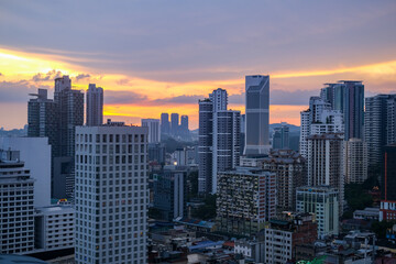 Obraz premium Sunset cityscape of Bukit Bintang in Kuala Lumpur, Malaysia, featuring modern skyscrapers and vibrant urban atmosphere in one of the city’s most popular tourist destinations.