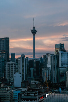 Bukit Bintang cityscape featuring the iconic Kuala Lumpur Tower rising prominently above dense urban skyline, capturing vibrant metropolitan atmosphere and popular tourism district in Malaysia