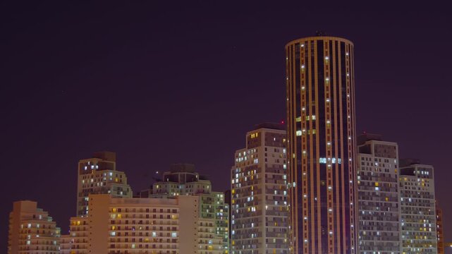 Timelapse: typical turkish multistory residential buildings with fast blinking illuminated windows and warm street lighting in Istanbul, Turkey at night. Architecture and time lapse concept