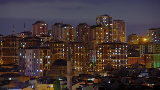 Timelapse: typical turkish multistory residential buildings with fast blinking illuminated windows and warm street lighting in Istanbul, Turkey at night. Architecture and time lapse concept
