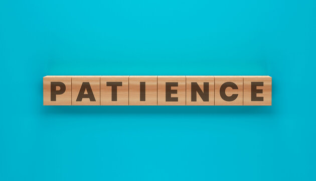Patience Word Blocks: Wooden blocks with the word PATIENCE printed on them, arranged in a straight line against a vibrant teal background, symbolizing a virtue.