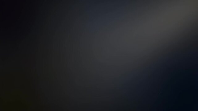 A dark, blurry, abstract background with a subtle light gradient in the upper right.
