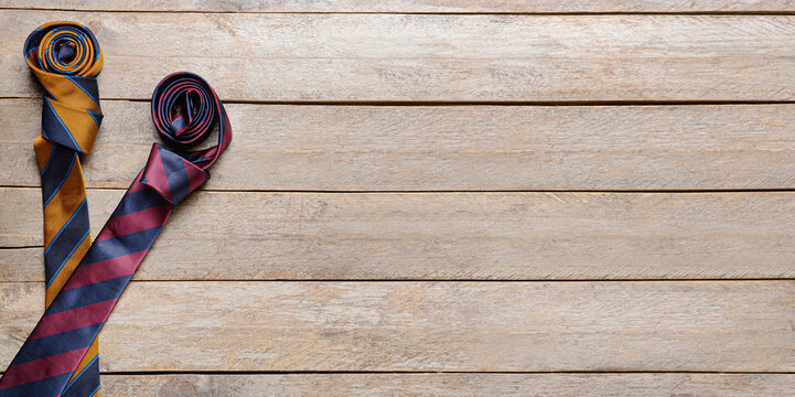 Stylish neckties on wooden background