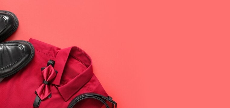 Stylish bow tie, male shirt, shoes and belt on red background with space for text