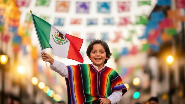Happy young Hispanic boy wearing traditional colorful poncho holding Mexican flag during festive street celebration