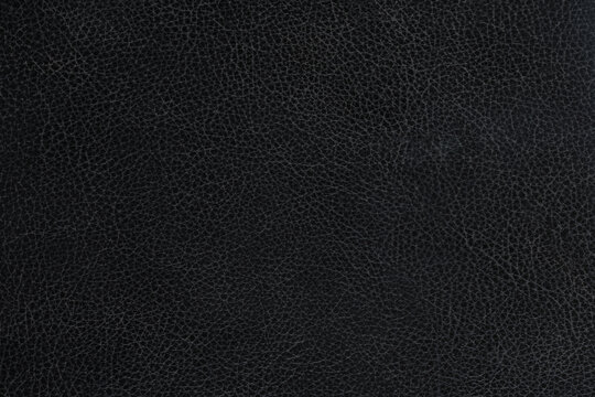 Black pebbled leather texture, dark synthetic material.