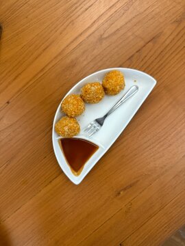 Crispy getuk goreng or fried  mashed cassava ball served with brown sugar sauce. Traditional food from Indonesia. 