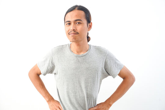Young handsome Indonesian, Asian man in gery shirt positive expression, joyful and exciting isolated on white background. Happy adorable glad man rejoices success